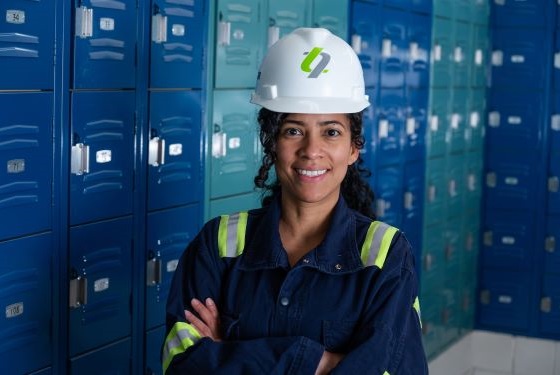Employee Safety Smiling female employee at Gopher Resource standing in front of lockers.